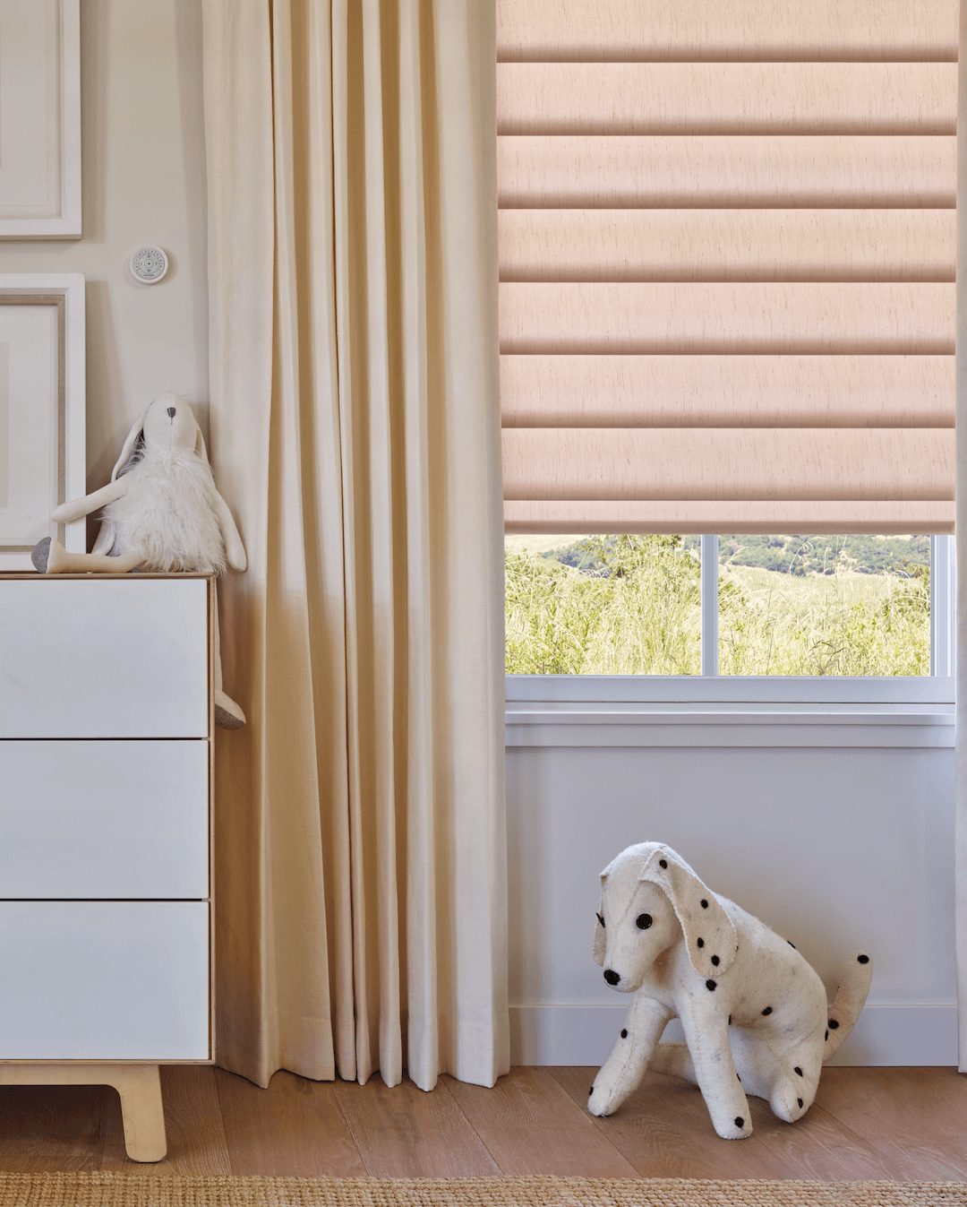 Nursery with motorized Pirouette® Sheer Shades with a wall-mounted Pebble remote